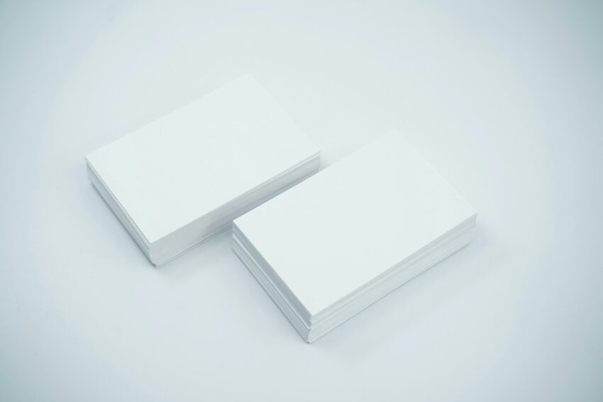 two blank business cards sitting on top of each other