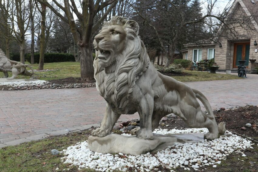 a statue of a lion sitting on top of a rock