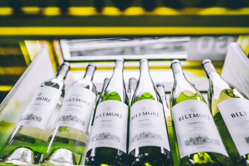 white labeled bottles on yellow and black shelf